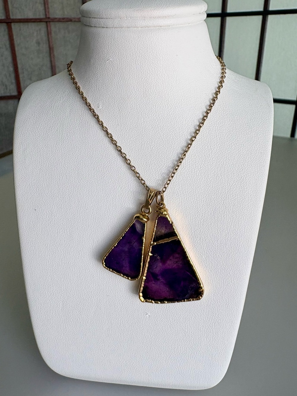 Two amethyst pendants + chain